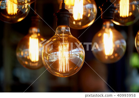 Edison light bulb hanging on a long wire. Cozy warm yellow light.Retro Edison light bulb hanging on a long wire. Cozy warm yellow light.Retro 40993958