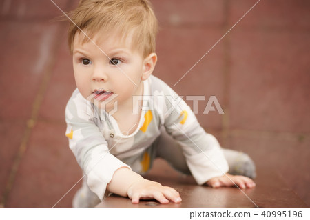 Portrait of adorable baby playing at playground Portrait of adorable baby playing at playground 40995196