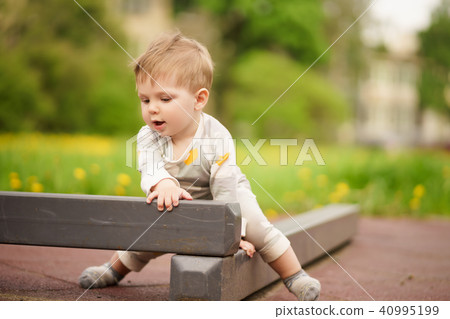 Portrait of adorable baby playing at playground Portrait of adorable baby playing at playground 40995199