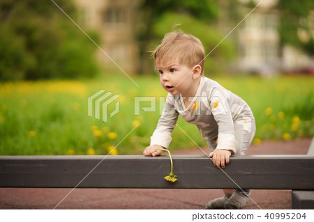 Portrait of adorable baby playing at playground Portrait of adorable baby playing at playground 40995204