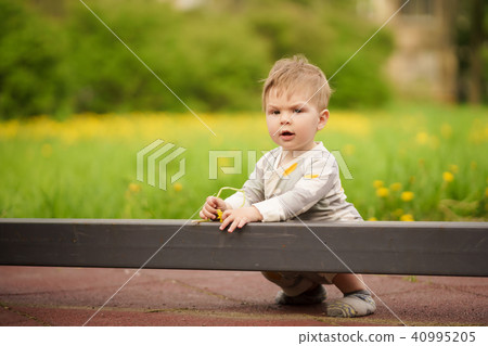 Portrait of adorable baby playing at playground Portrait of adorable baby playing at playground 40995205