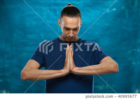 Cute man posing on blue background 40995677