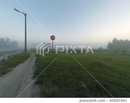 Railway crossing, foggy morning, 40995991