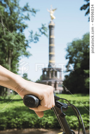 man riding a bike in front of the Victory Column 40996834