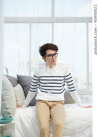 Man resting on bed Man resting on bed 40998921