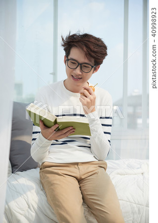Enjoying a book 40998923