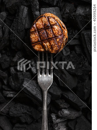 Grilled juicy beef pork steak on barbecue coil 40999264