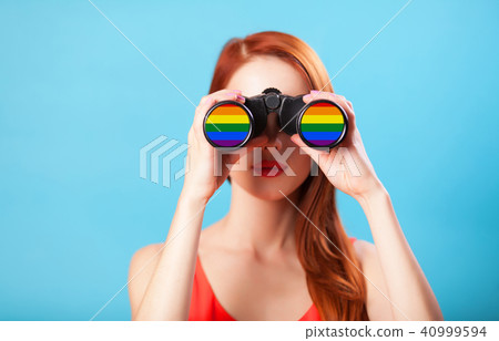 Redhead girl with binocular 40999594