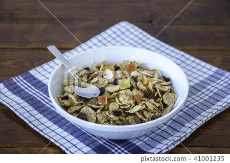 A bowl full of muesli cereals with spoon A bowl full of muesli cereals with spoon 41001235