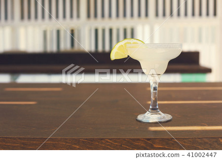 Cocktail glass on outdoor bar counter 41002447