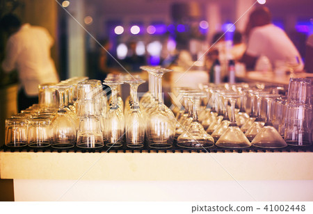 Empty glasses on bar counter Empty glasses on bar counter 41002448