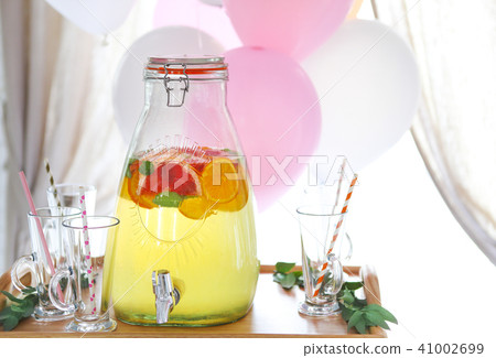 Citrus homemade lemonade in a beverage dispencer 41002699