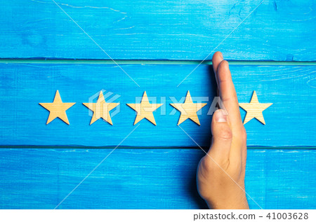 hand divides the fifth star from the four others hand divides the fifth star from the four others 41003628