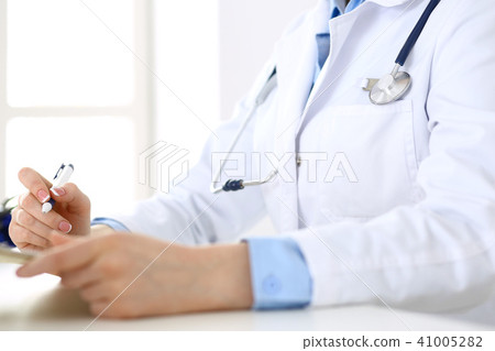 Female doctor filling up medical form on clipboard closeup. Healthcare, insurance and medicine 41005282