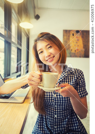 Woman with laptop and cup. Vacations concept. Woman with laptop and cup. Vacations concept. 41006975