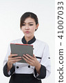 portrait of asia clef woman with tablet on white  41007033