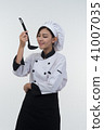 portrait of asia clef woman with ladle on white 41007035