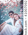 Asia loving couple in blossom spring garden 41007092