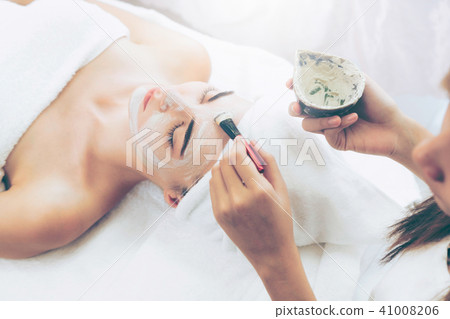 Beautiful woman having a facial treatment at spa. Beautiful woman having a facial treatment at spa. 41008206