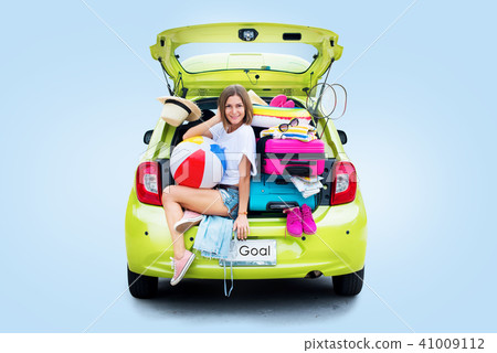 Ready to travel. Woman in green car before trip Ready to travel. Woman in green car before trip 41009112