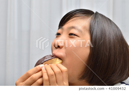 A girl who eats Eclair deliciously 41009432