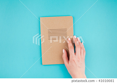 Woman hands holding craft paper diary Woman hands holding craft paper diary 41010081