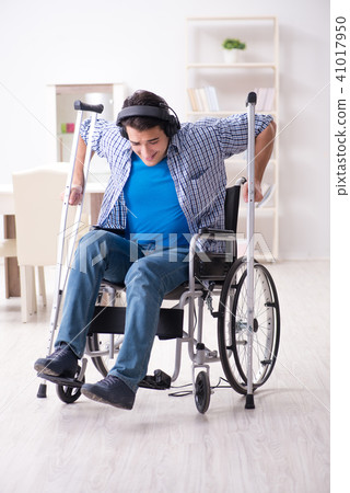 Disabled man listening to music in wheelchair 41017950