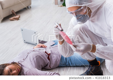 Forensic investigator at the crime scene investigating woman mur 41018313