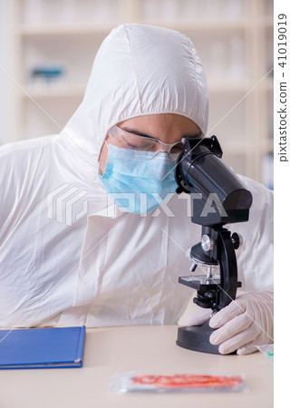 Expert criminologist working in the lab for evidence 41019019