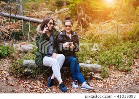 two beautiful girls sat down in the forest two beautiful girls sat down in the forest 41019098