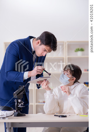 Expert criminologist working in the lab for evidence 41019201