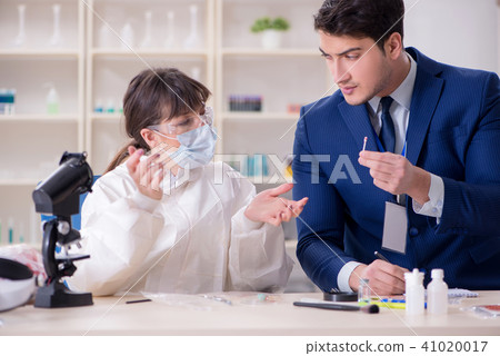 Expert criminologist working in the lab for evidence Expert criminologist working in the lab for evidence 41020017