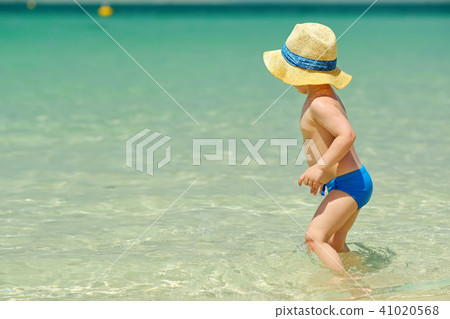 Two year old toddler playing on beach 41020568