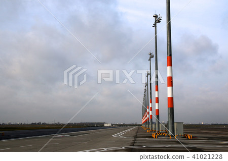 BERLIN, GERMANY - JAN 17th, 2015: View of empty apron with parking positions and lights. Tarmac at BERLIN, GERMANY - JAN 17th, 2015: View of empty apron with parking positions and lights. Tarmac at 41021228