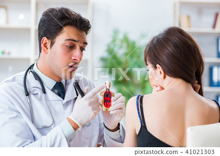 Doctor checking patients ear during medical examination Doctor checking patients ear during medical examination 41021303