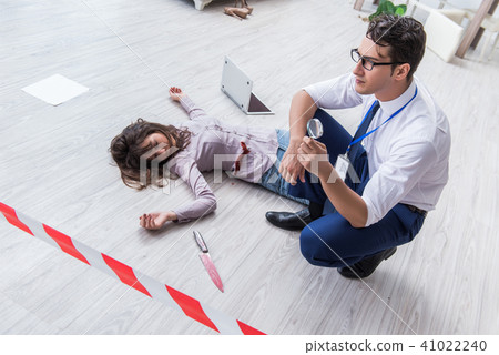 Forensic investigator at the crime scene investigating woman mur 41022240