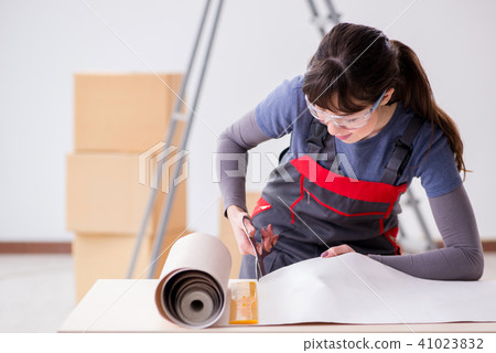 Woman preparing for wallpaper work Woman preparing for wallpaper work 41023832