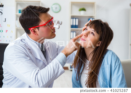 Doctor examining patients eye in hospital Doctor examining patients eye in hospital 41025287