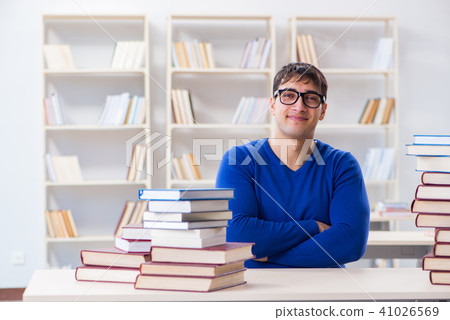 Male student preparing for exams in college library 41026569