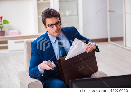 Businesman watching tv in office Businesman watching tv in office 41026620