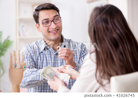 Woman visiting jeweler for jewelery evaluation Woman visiting jeweler for jewelery evaluation 41026745