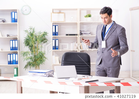 Forensics investigator at the scene of office crime 41027119