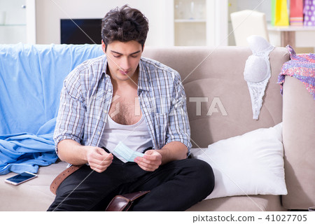 Man with mess at home after house party 41027705