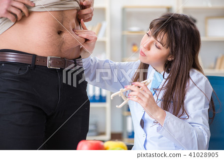 Doctor dietician giving advices to fat overweight patient 41028905