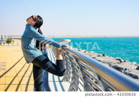 Girl stretching before workout by the seaside Girl stretching before workout by the seaside 41030638