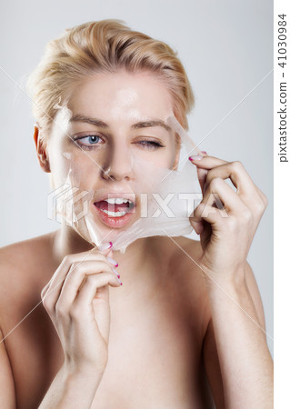 Beautiful woman cleaning her face Beautiful woman cleaning her face 41030984