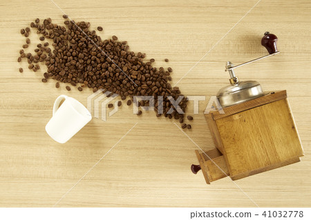 Coffee grinder with coffee beans on wooden Coffee grinder with coffee beans on wooden 41032778
