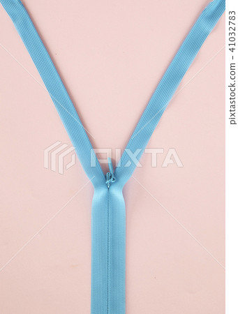 Blue zipper with pink background Blue zipper with pink background 41032783
