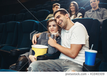 Smiling couple watching comedy movie in cinema 41040309