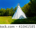 white teepee indian tent standing in beautiful summer landscape. 41041585